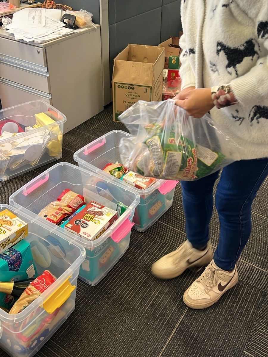 Una colaboradora de Glore arma una caja de regalo navideño con alimentos